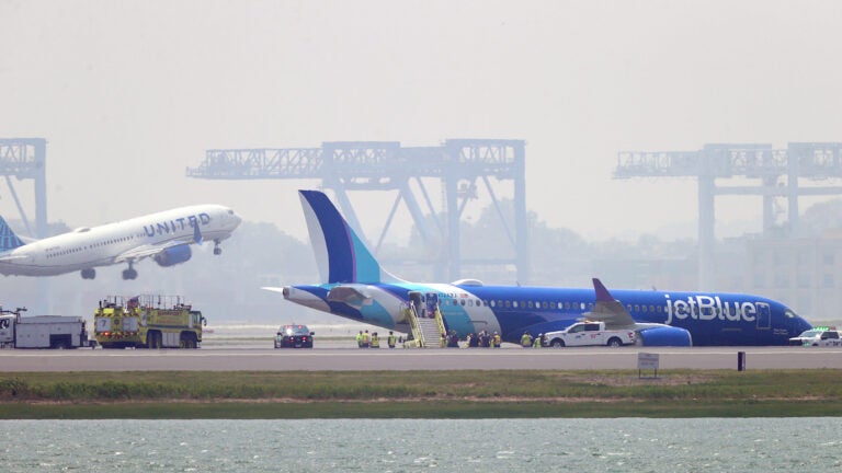 Video shows plane rolling off Logan runway